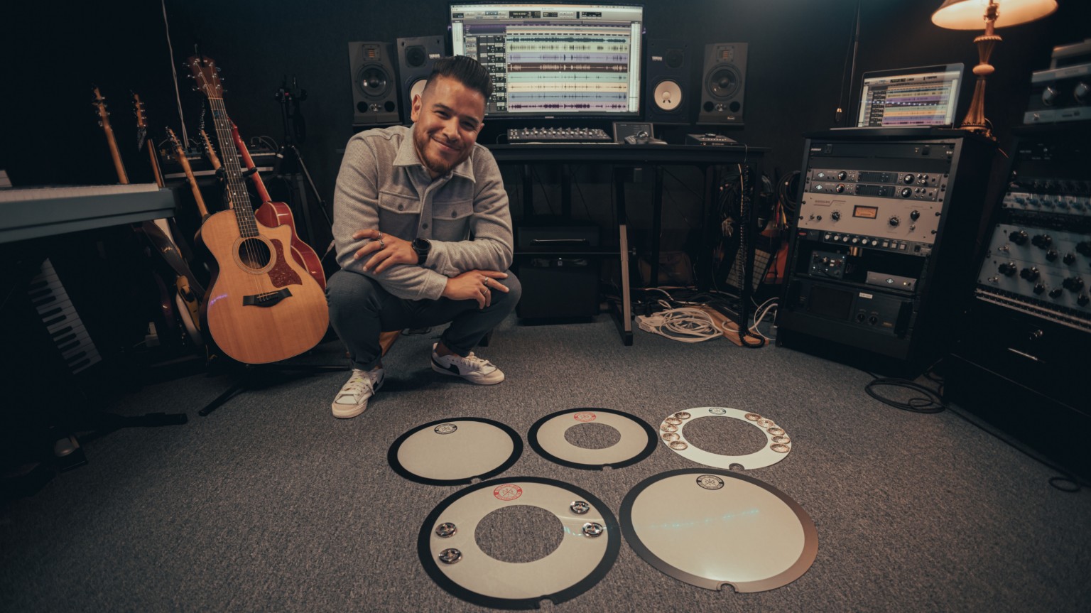 Kevin Michael Chong with a collection of Big Fat Snare Drum accessories in the studio