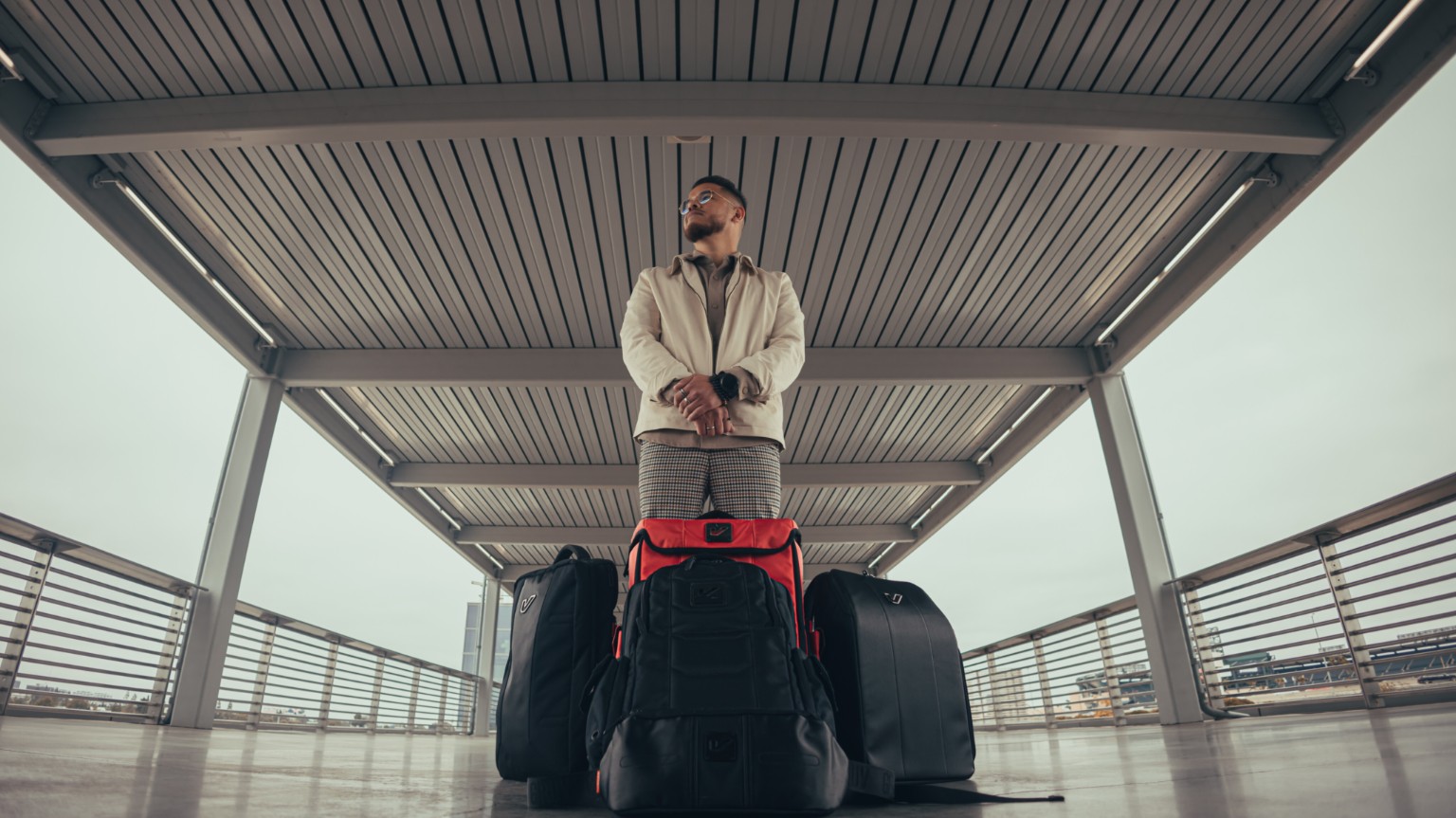 Kevin Michael Chong standing behind a collection of GruvGear bags