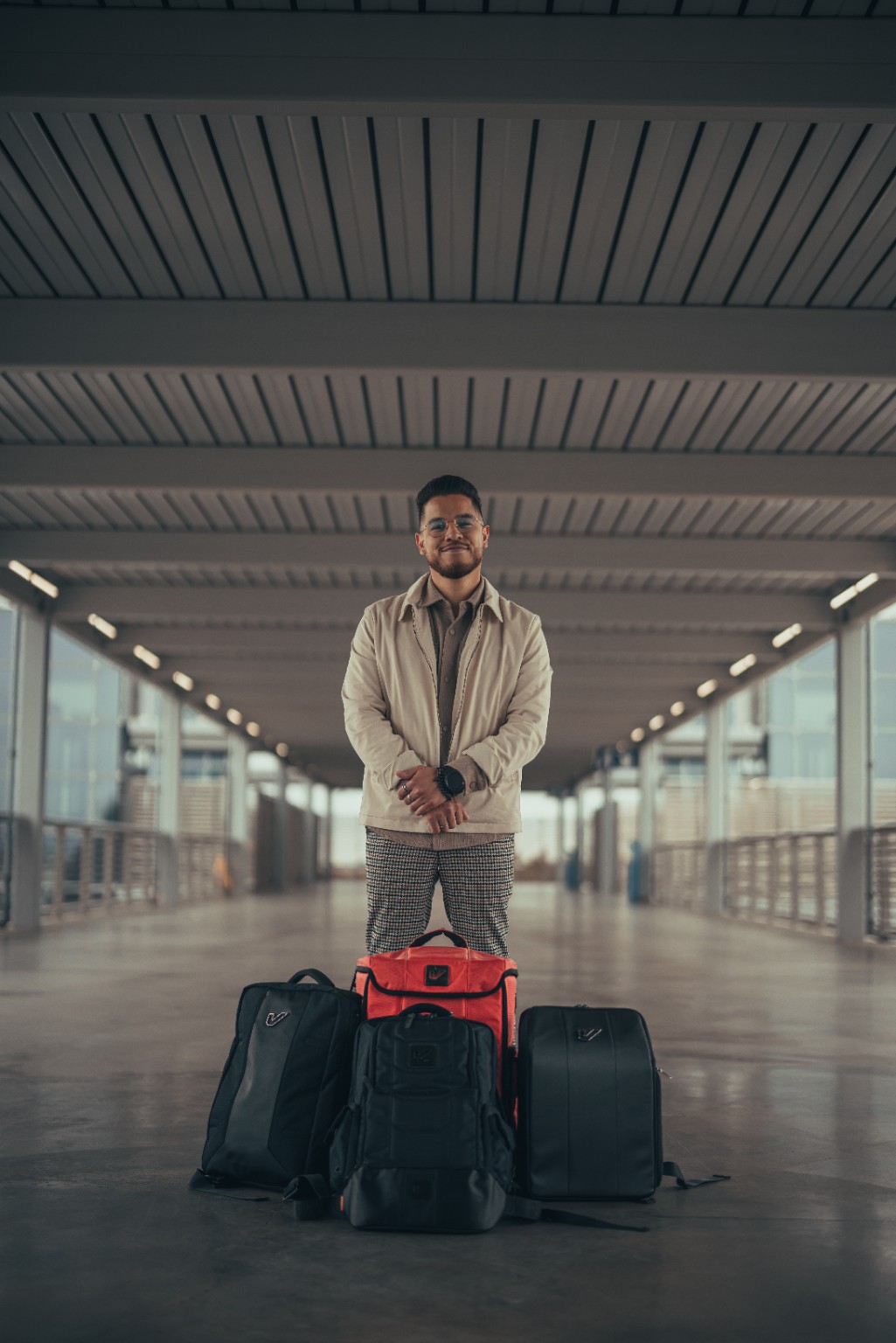 Kevin Michael Chong standing behind Gruv Gear bags